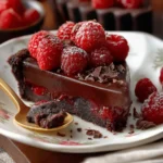 Dark chocolate raspberry tart with fresh raspberries and glossy ganache