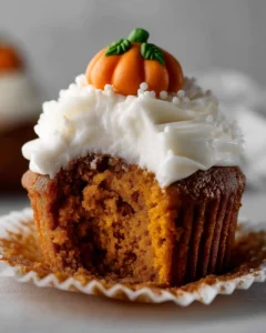 Finished pumpkin cupcakes with cream cheese frosting and decorative pumpkin on top